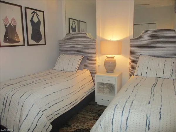 a bedroom with a bed and night stand