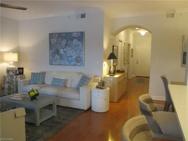 a living room with furniture and a chandelier
