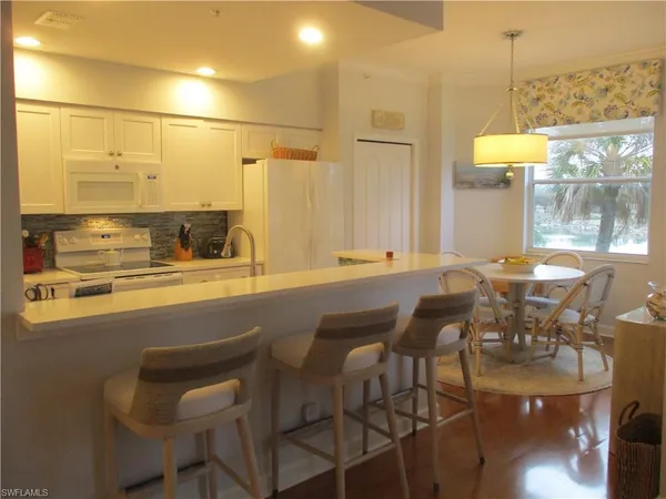 a view of a dining room with furniture and a window