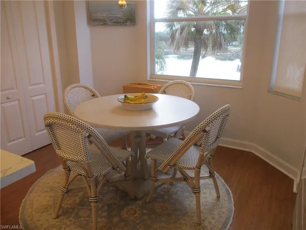 a view of a dining room with furniture and window