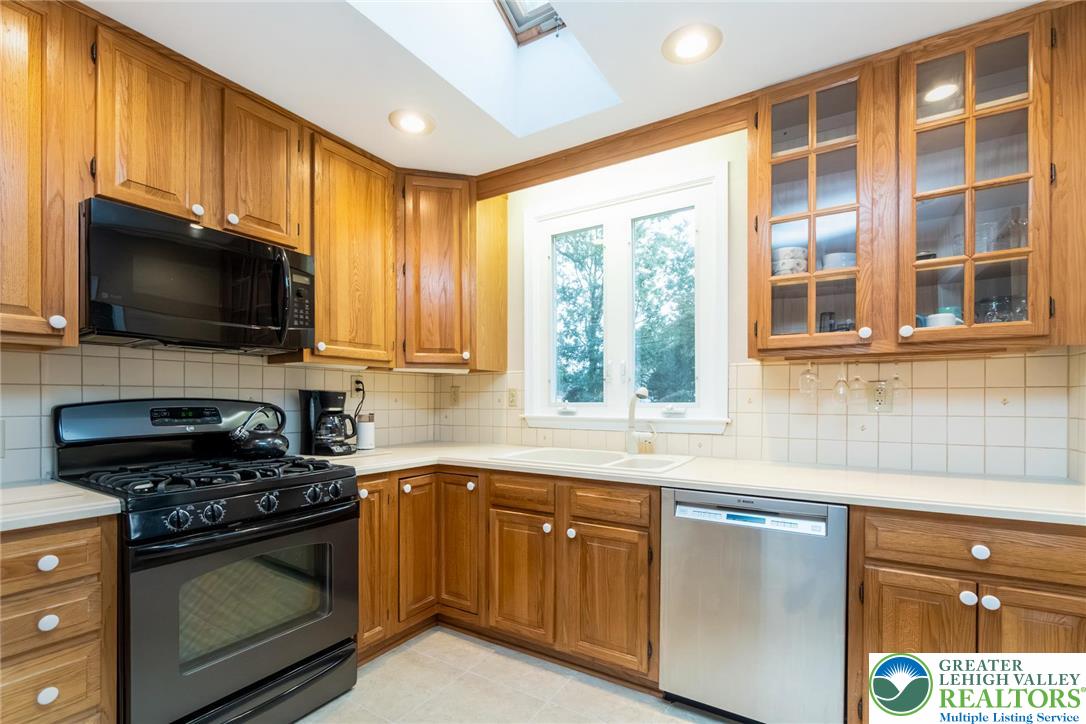 898 Walnut Road Warminster, PA 18974 - Photo 17 of 47 a kitchen with granite countertop a stove and a sink