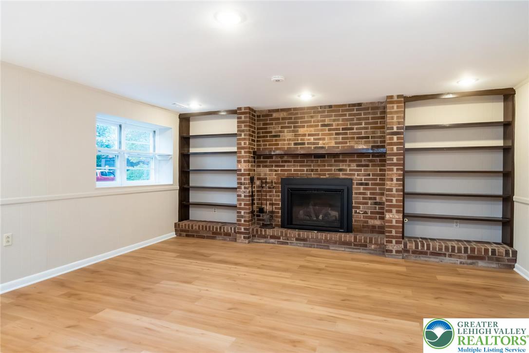 898 Walnut Road Warminster, PA 18974 - Photo 27 of 47 a view of an empty room with a fireplace and a window