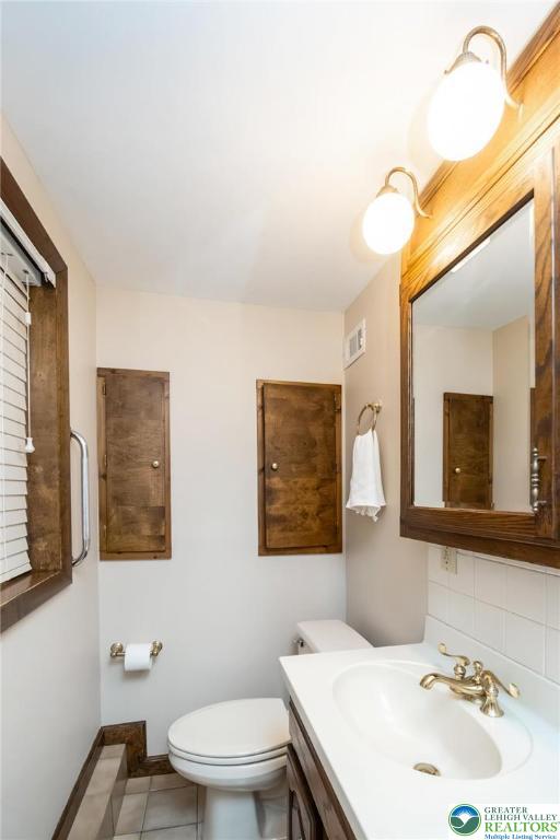898 Walnut Road Warminster, PA 18974 - Photo 32 of 47 a bathroom with a sink mirror and a toilet