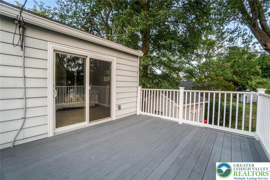 898 Walnut Road Warminster, PA 18974 - Photo 38 of 47 a view of backyard with wooden deck and a floor to ceiling window