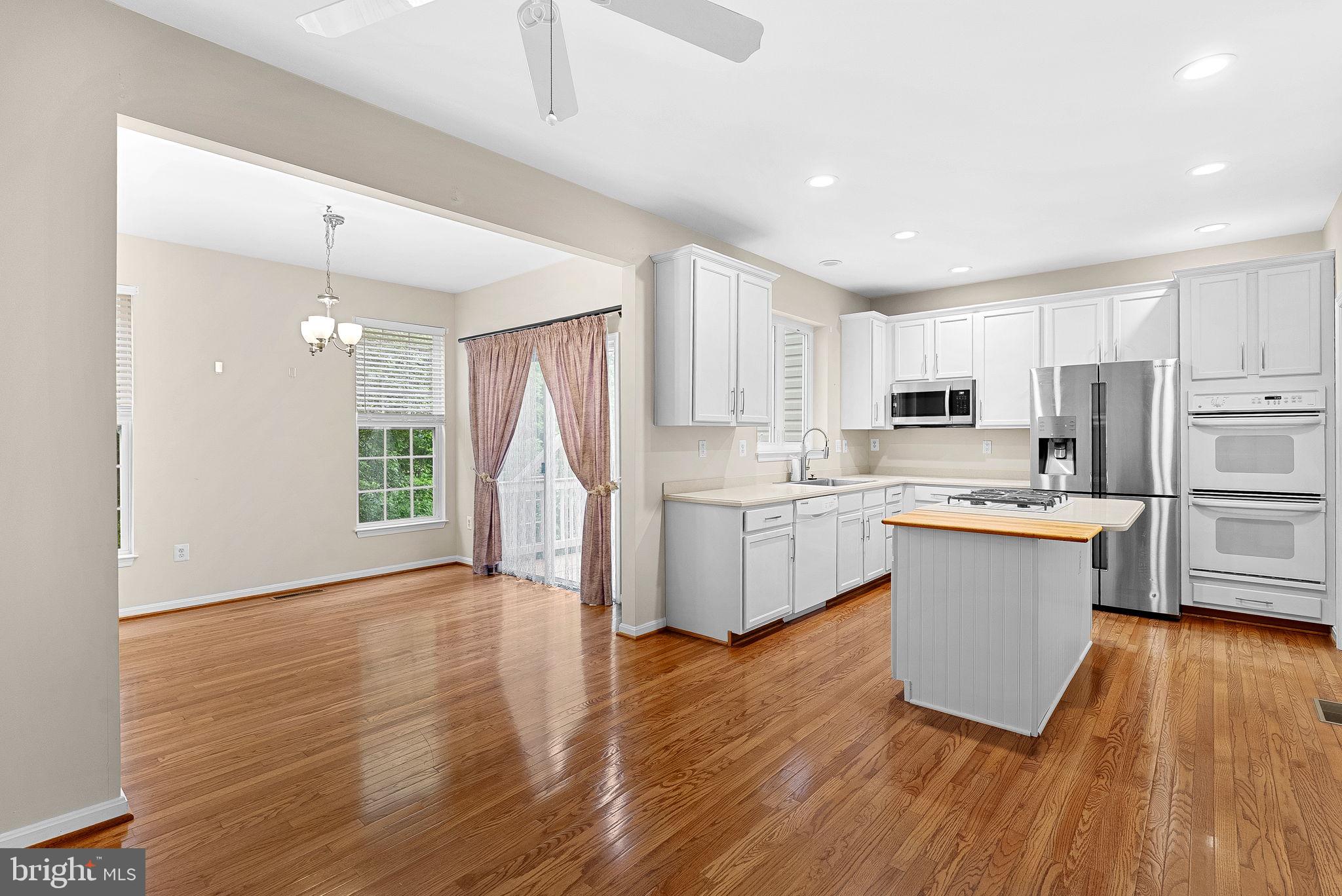 13574 Big Boulder Road Herndon, VA 20171 - Photo 12 of 45 a kitchen with white cabinets and white appliances