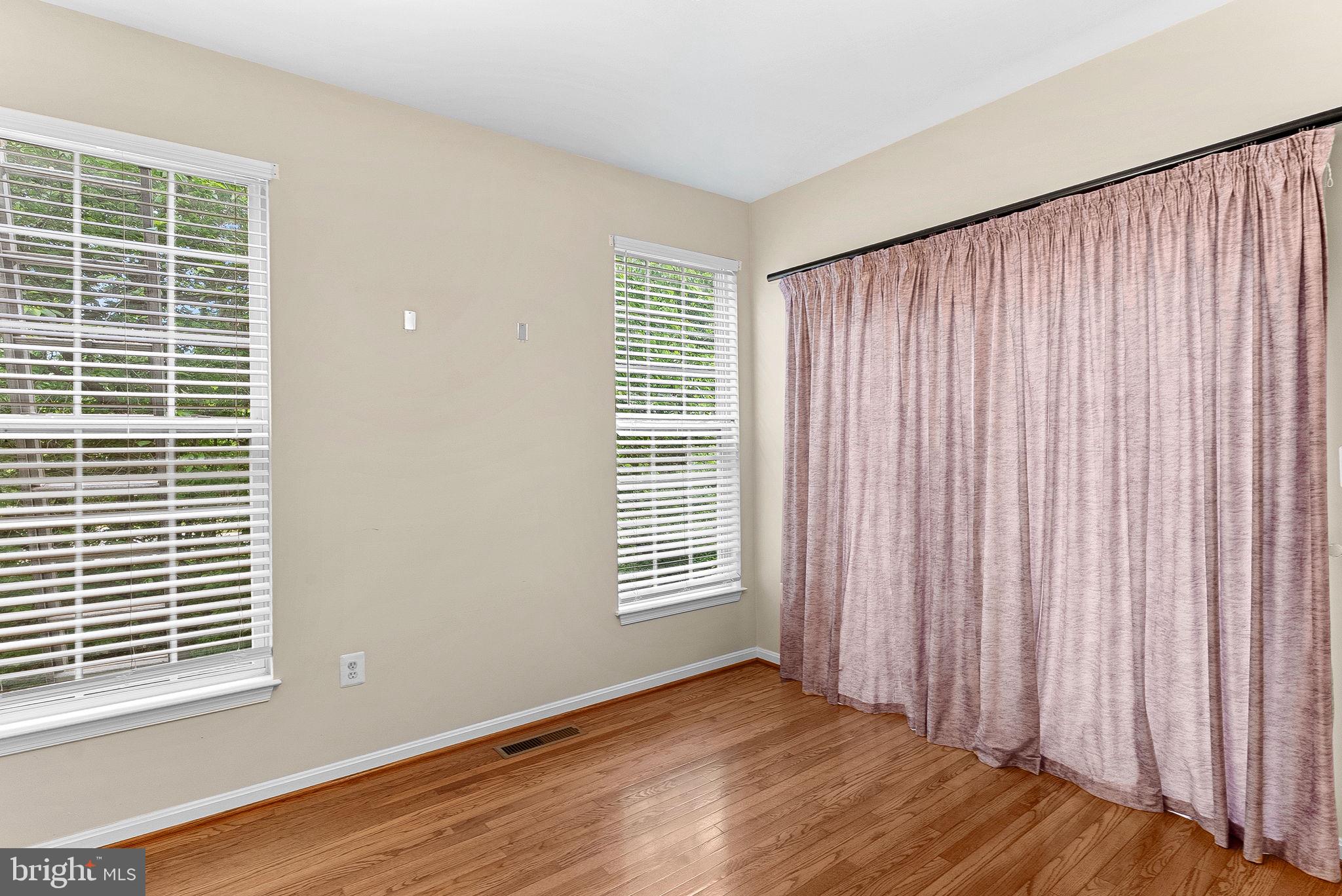 13574 Big Boulder Road Herndon, VA 20171 - Photo 17 of 45 a view of an empty room with wooden floor and a window