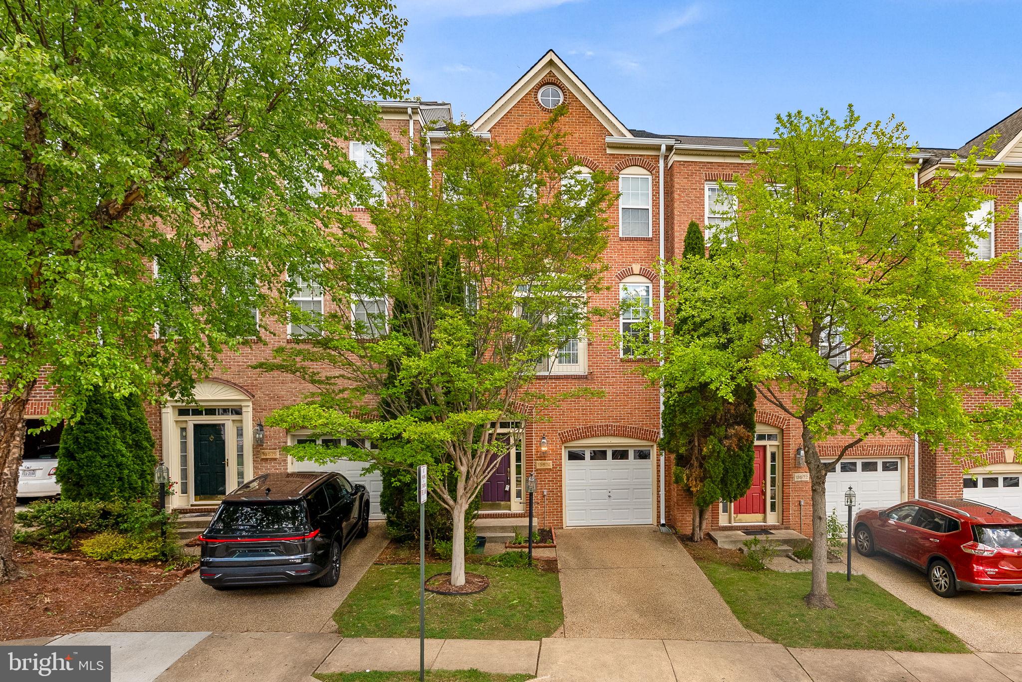 13574 Big Boulder Road Herndon, VA 20171 - Photo 2 of 45 a front view of a house with a garden