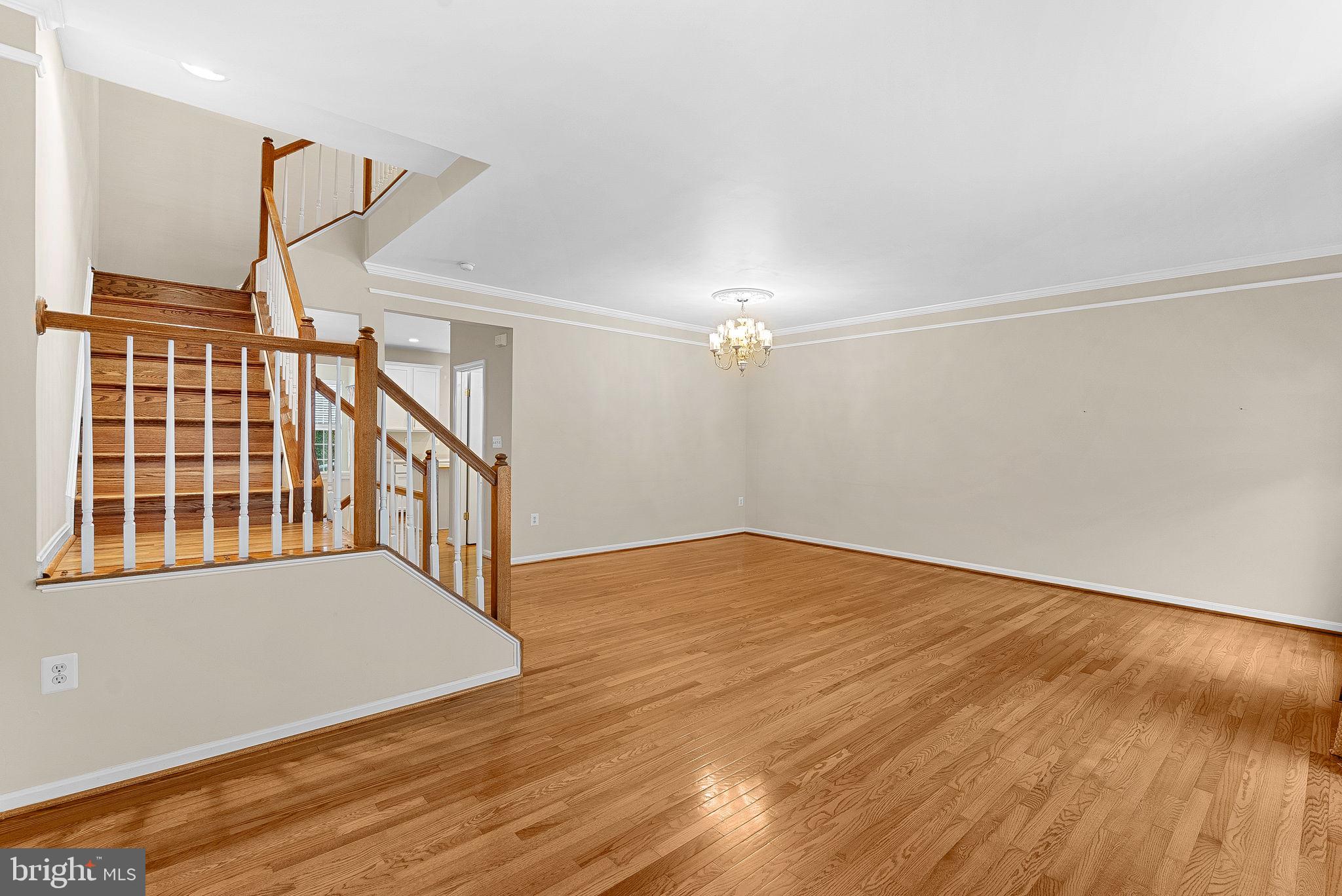 13574 Big Boulder Road Herndon, VA 20171 - Photo 21 of 45 a view of an empty room with stairs and wooden floor
