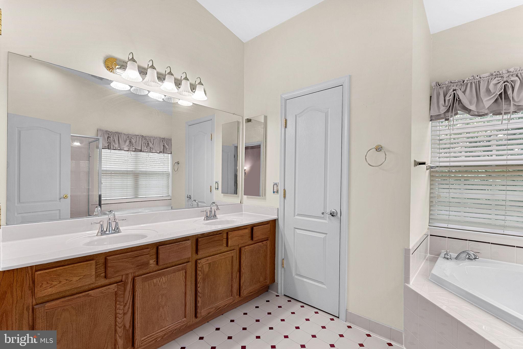 13574 Big Boulder Road Herndon, VA 20171 - Photo 31 of 45 a bathroom with a sink double vanity and a shower