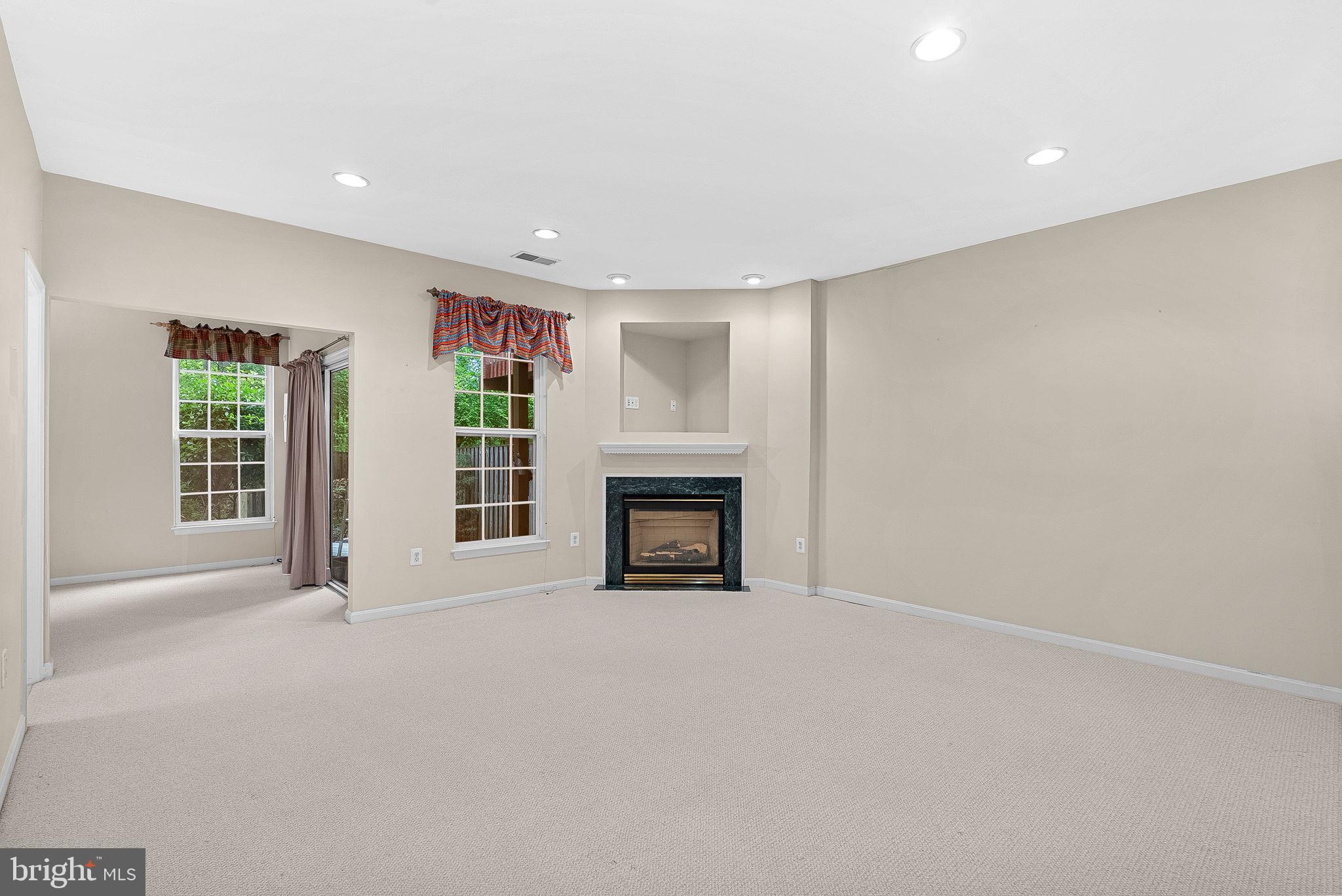 13574 Big Boulder Road Herndon, VA 20171 - Photo 4 of 45 a view of an empty room with a fireplace and a window