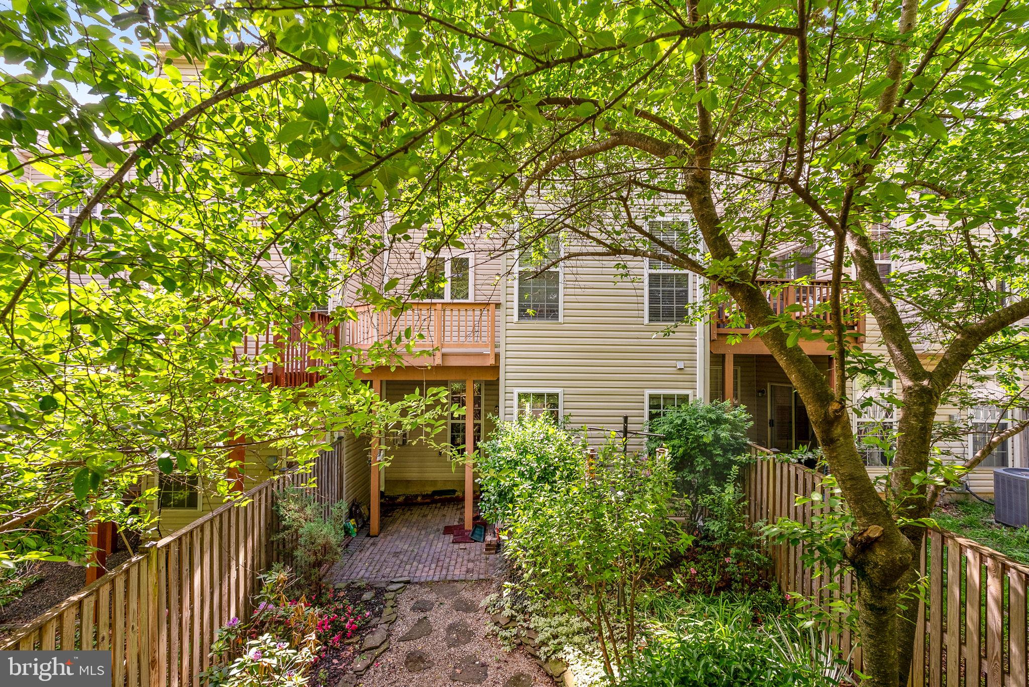 13574 Big Boulder Road Herndon, VA 20171 - Photo 43 of 45 a yellow house with trees in front of it