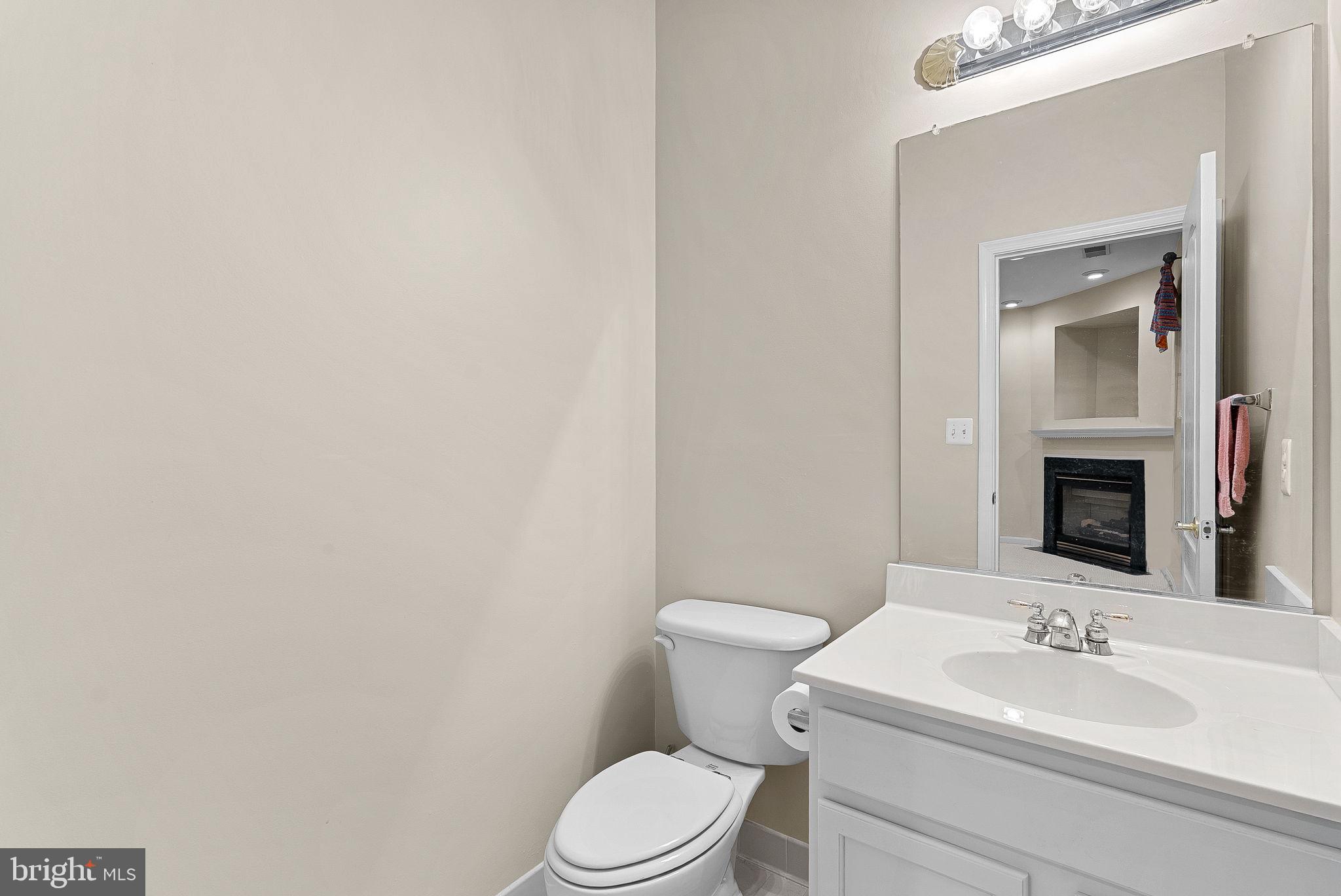 13574 Big Boulder Road Herndon, VA 20171 - Photo 9 of 45 a bathroom with a toilet a sink and mirror