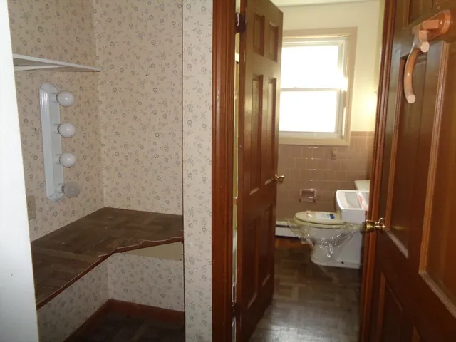 a bathroom with a toilet and a shower