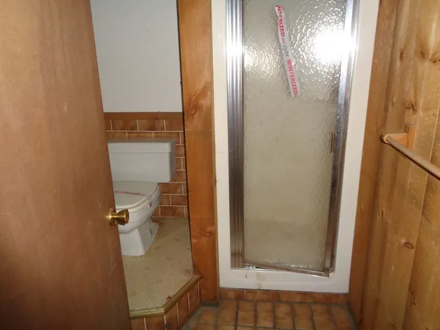a bathroom with a glass shower door