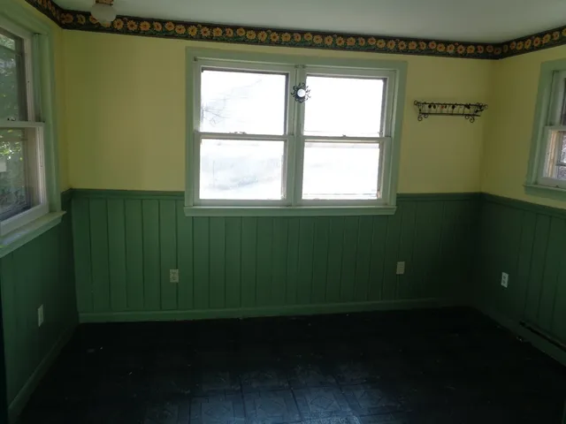 a room with a window and a wooden floor