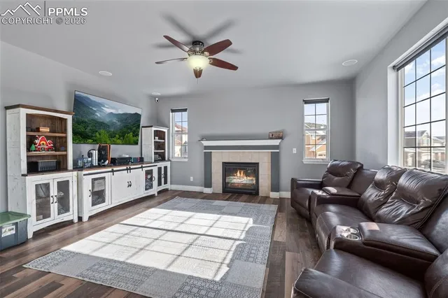 a living room with furniture a flat screen tv and a fireplace