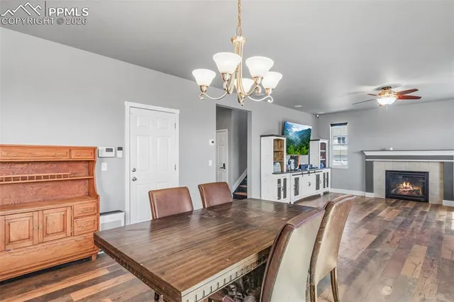 a living room with furniture a fireplace and chandelier
