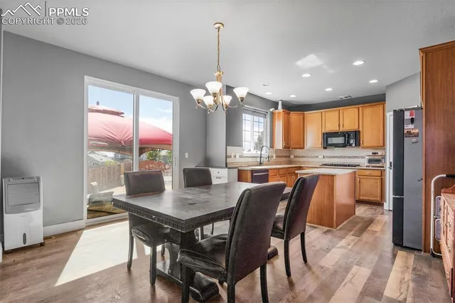 a view of a dining room with furniture window and wooden floor