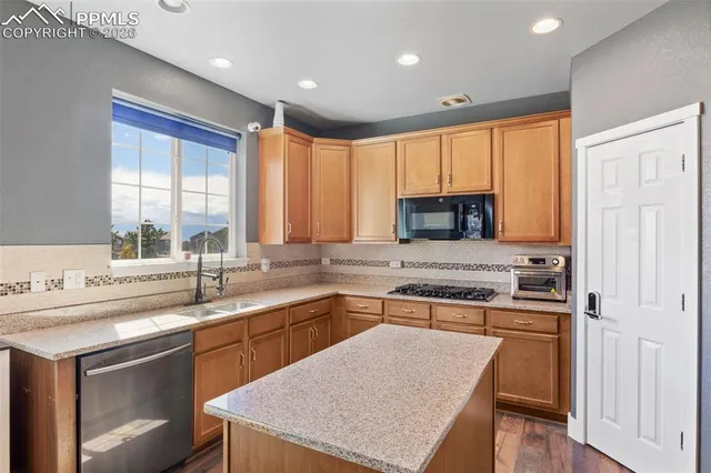 a kitchen with a stove a sink and a refrigerator