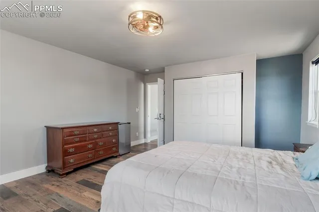 a bedroom with a bed and a dresser