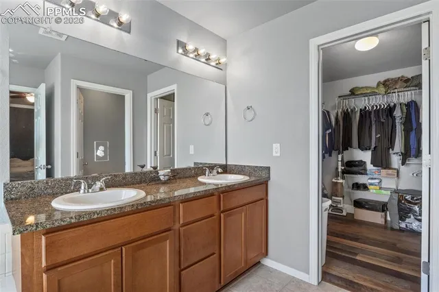 a bathroom with a sink double vanity and a mirror