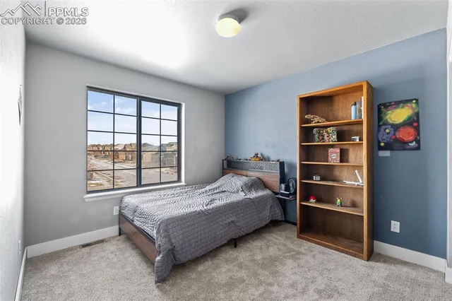 a bed sitting in a room next to a window