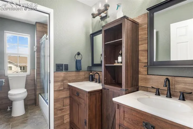 a bathroom with a sink double vanity and a toilet