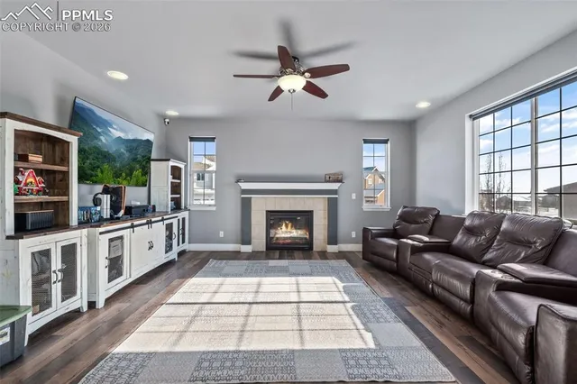 a living room with furniture fireplace and window