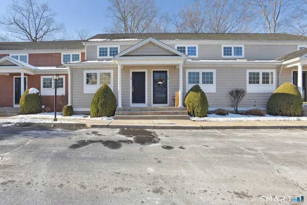 front view of a brick house with a outdoor space
