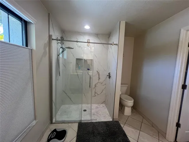 a bathroom with a shower and toilet