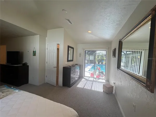 a living room with furniture tv and a window