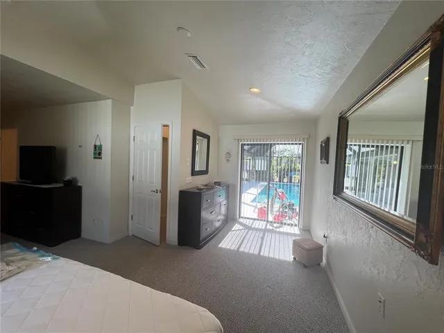 a living room with furniture tv and a window