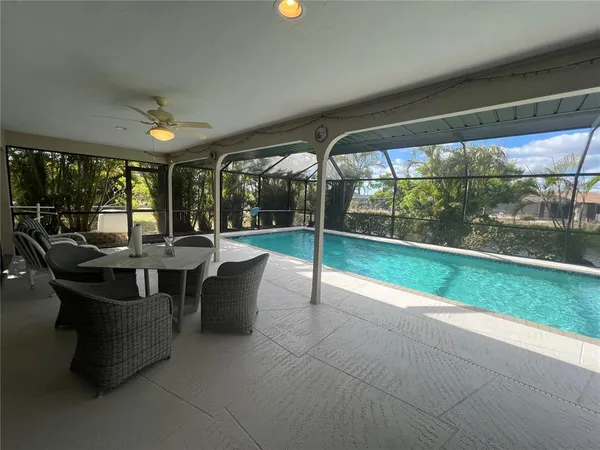 a view of a patio with dining table and chairs