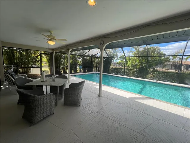 a view of a patio with dining table and chairs