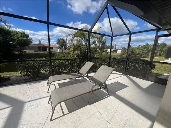 a view of patio with a table and chairs under an umbrella