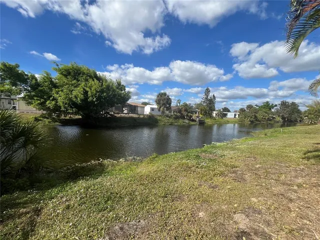 a view of a lake with houses in the back