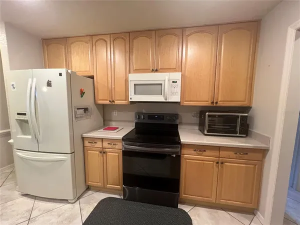 a kitchen with a refrigerator stove and microwave