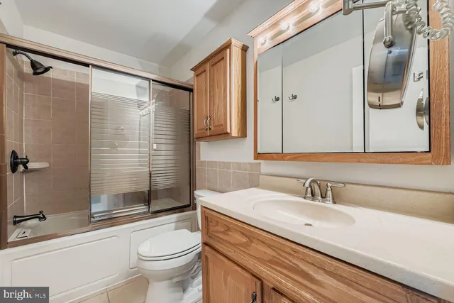 an empty room with sliding glass door and shower