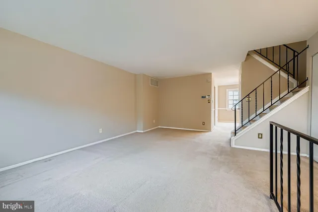a view of an empty room with stairs