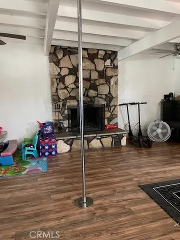 a room with lots of white furniture and wooden floor