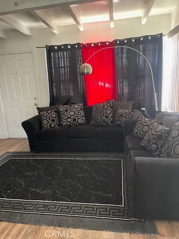 a wooden floor with window and a fireplace