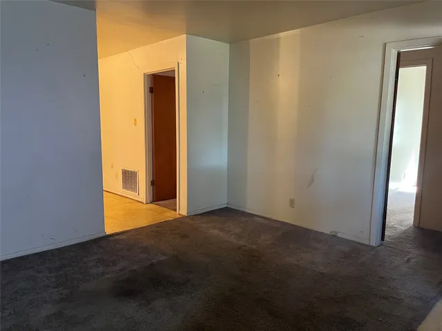 an empty room with closet area