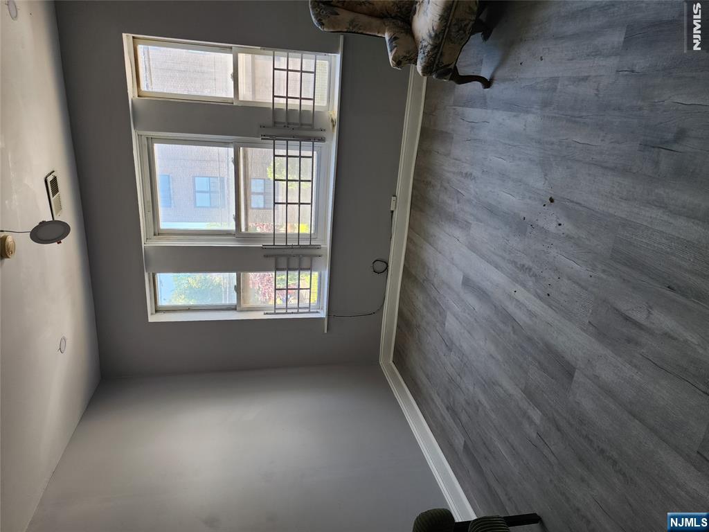 347 Avon Avenue Newark, NJ 07108 - Photo 4 of 4 an empty room with wooden floor and windows