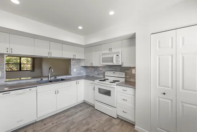 a view of hallway with wooden floor