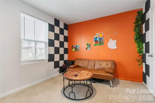 a living room with furniture a rug and a window