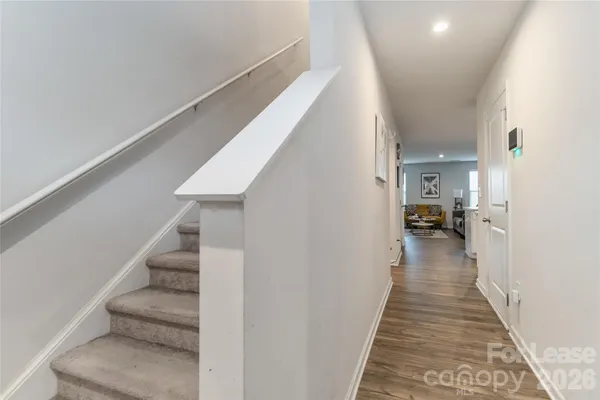 a view of a hallway view with lots of frames and chairs
