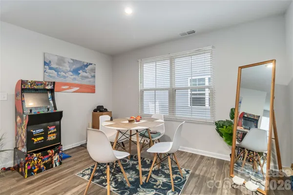 a dining room with furniture and wooden floor