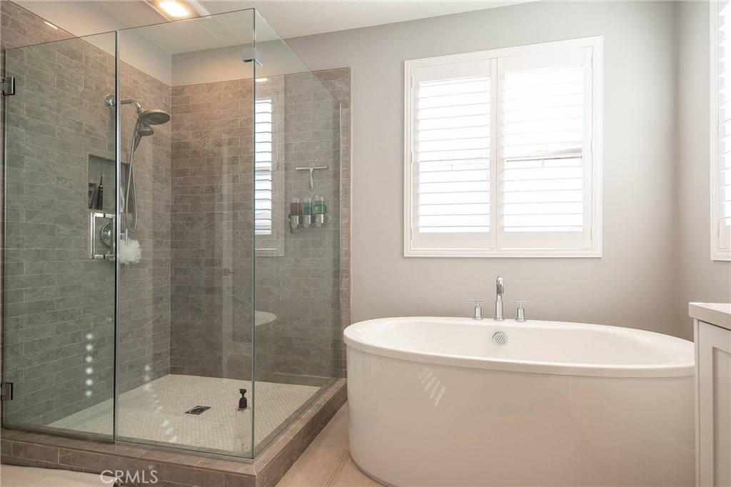 119 Wheatgrass Irvine, CA 92618 - Photo 14 of 32 a bathroom with a bathtub and shower