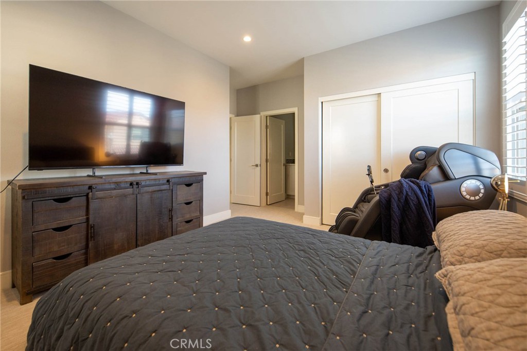 119 Wheatgrass Irvine, CA 92618 - Photo 22 of 32 a bedroom with a bed and a flat screen tv