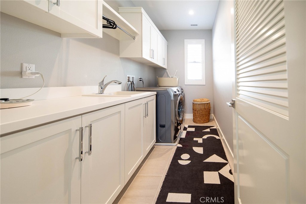 119 Wheatgrass Irvine, CA 92618 - Photo 23 of 32 a utility room with sink dryer and washer